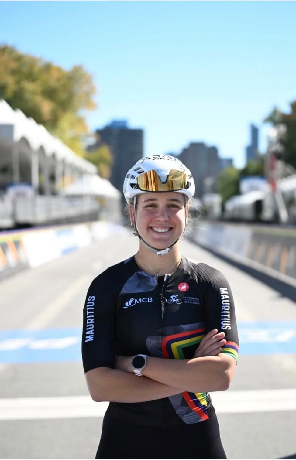 Mauritian road cyclist smiling in national team kit with helmet and sunglasses