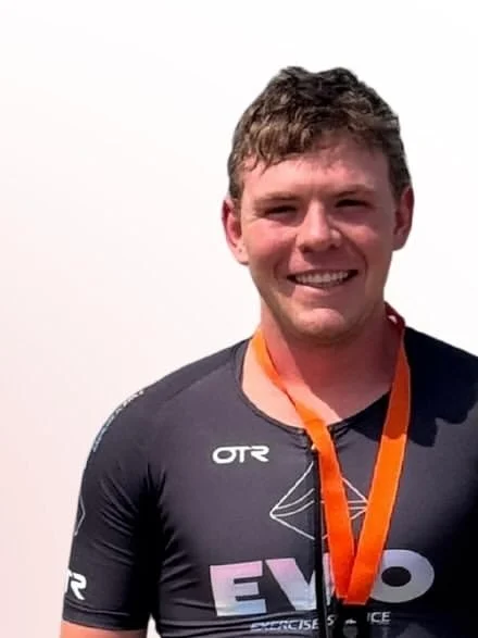 Cameron smiling with his finisher medal