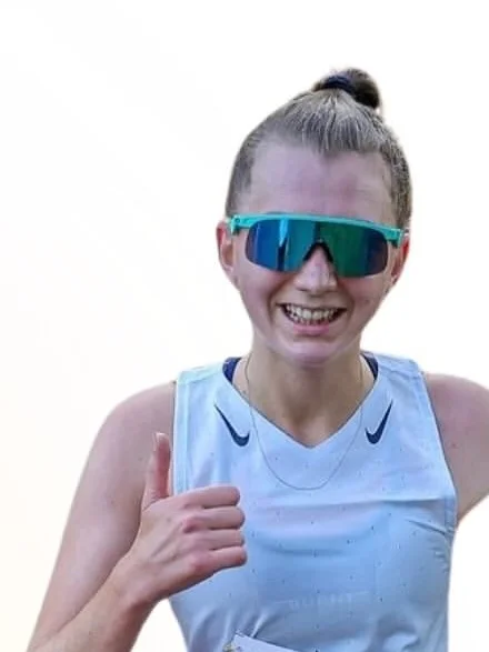 Sammy smiling and giving a thumbs up mid-run