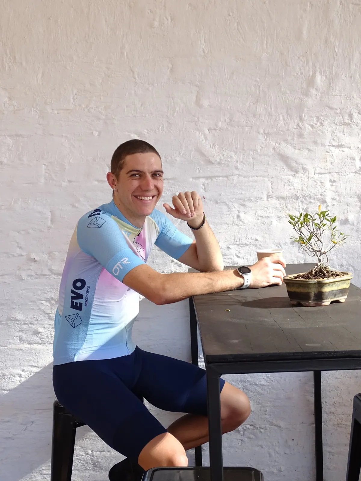James Allan smiling at a cafe table in EVO kit