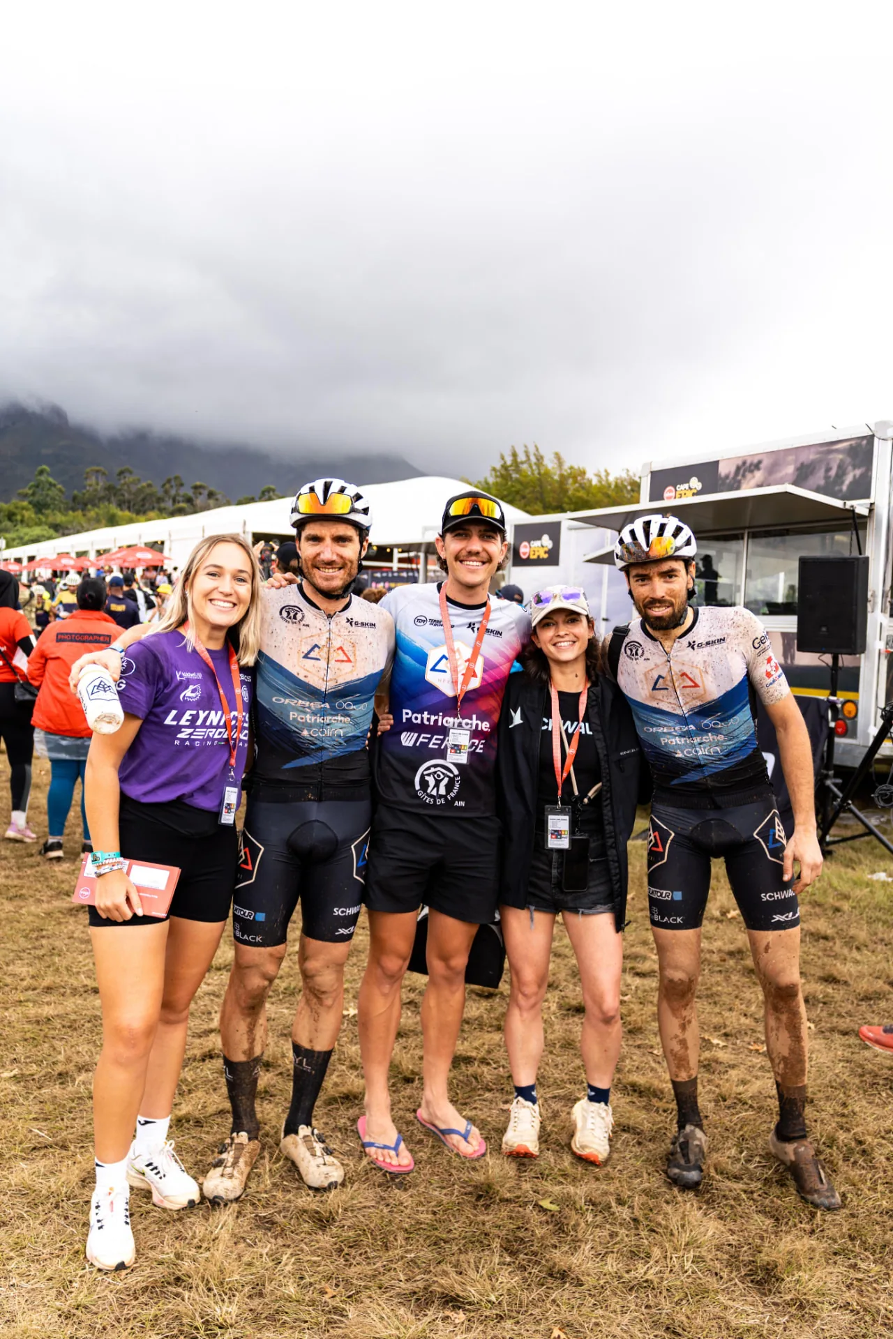 Five cyclists and supporters together at the Cape Epic race village